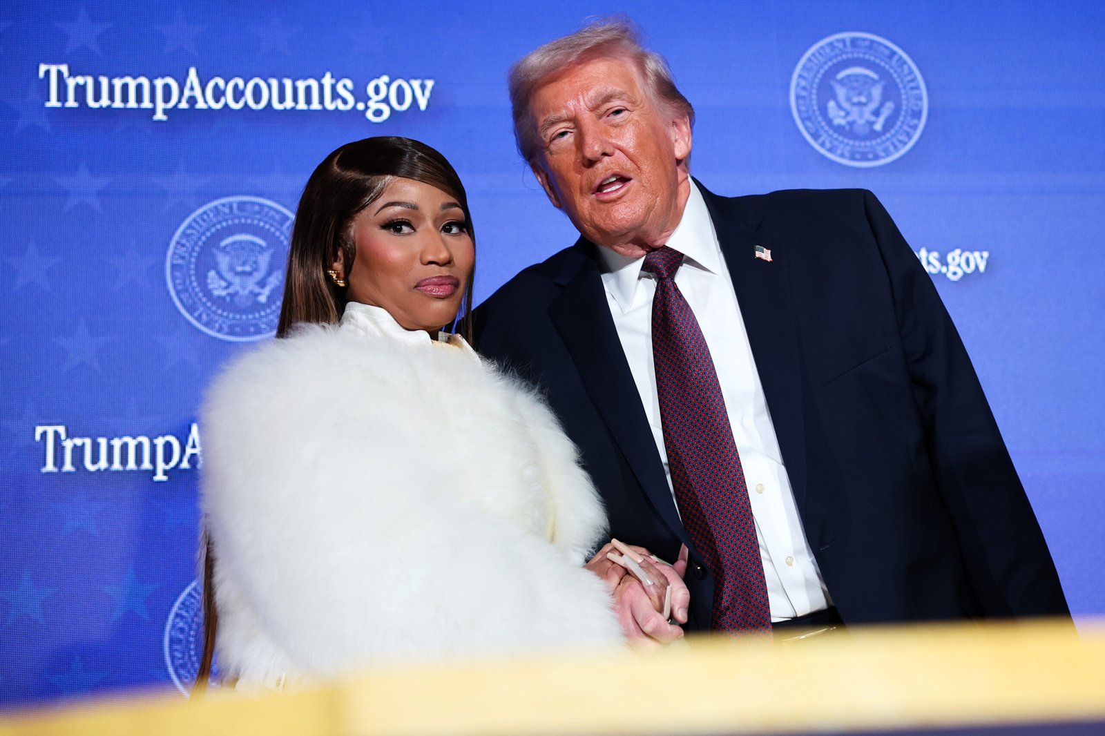 Nicki Minaj joins President Donald Trump on stage as he delivers remarks during the Treasury Department's Trump Accounts Summit on Jan. 28, 2026, in Washington.