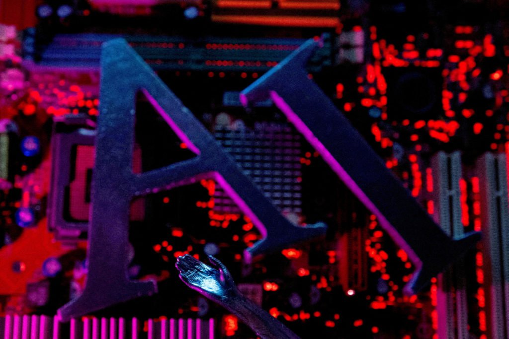 FILE PHOTO: Illustration shows AI (Artificial Intelligence) letters and robot hand