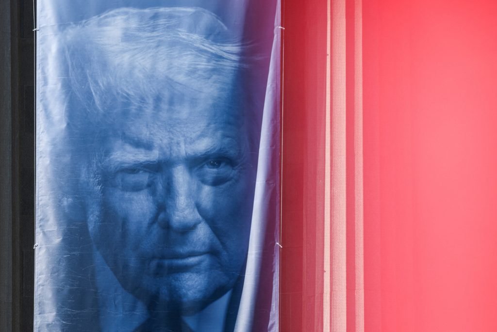 A banner depicting U.S. President Donald Trump hangs outside the Department of Justice building in Washington