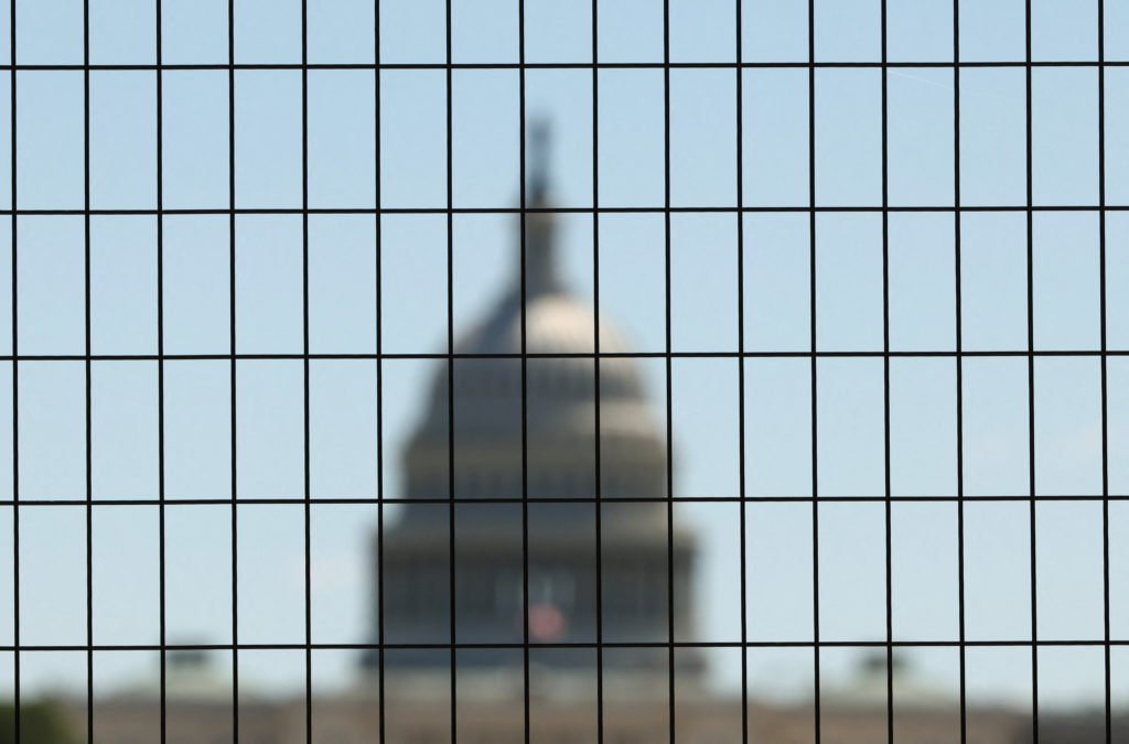 Dome of the U.S. Capitol seen through construction fencing as preparations for Freedom 250 continue along the National Mal...